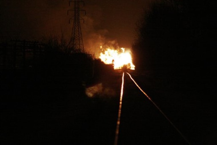 In this image provided by ABC affiliate WTVG 13, a fire burns at the scene of a freight train derailment near Arcadia, Ohio, on Sunday.